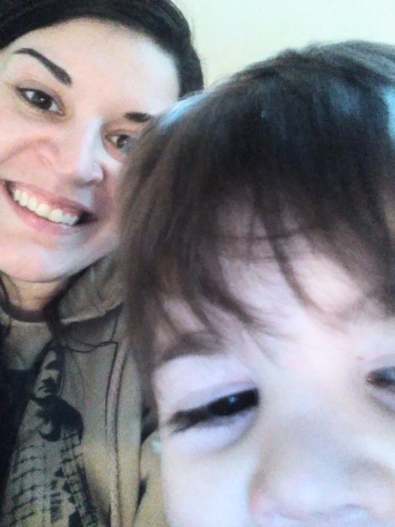 Close up of woman's and boy's smiling faces.