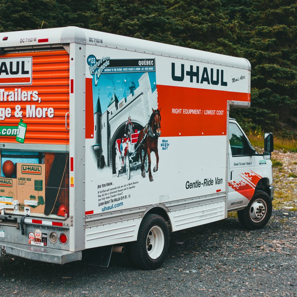 Close up of a white and orange uhaul moving truck.