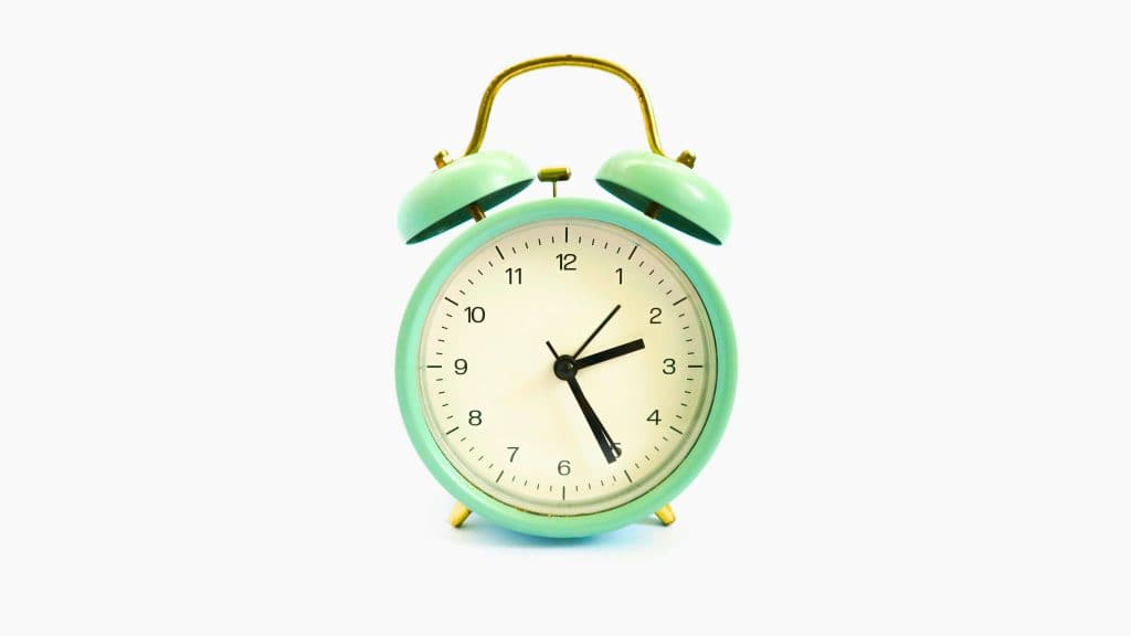 Light green circular alarm clock.