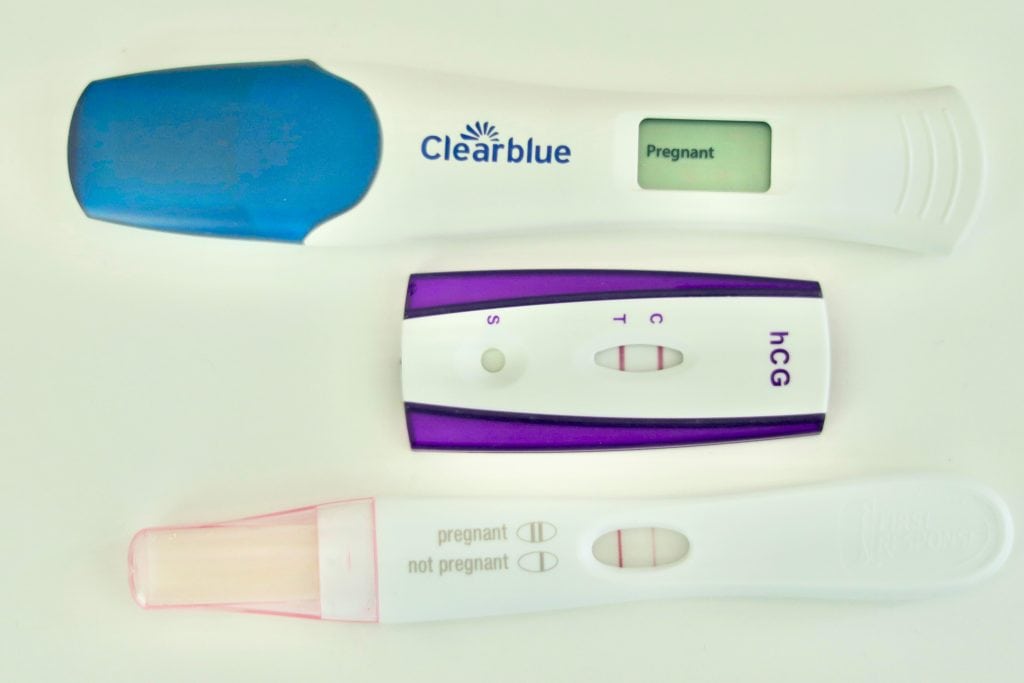 Three various pregnancy tests all reading Pregnant.